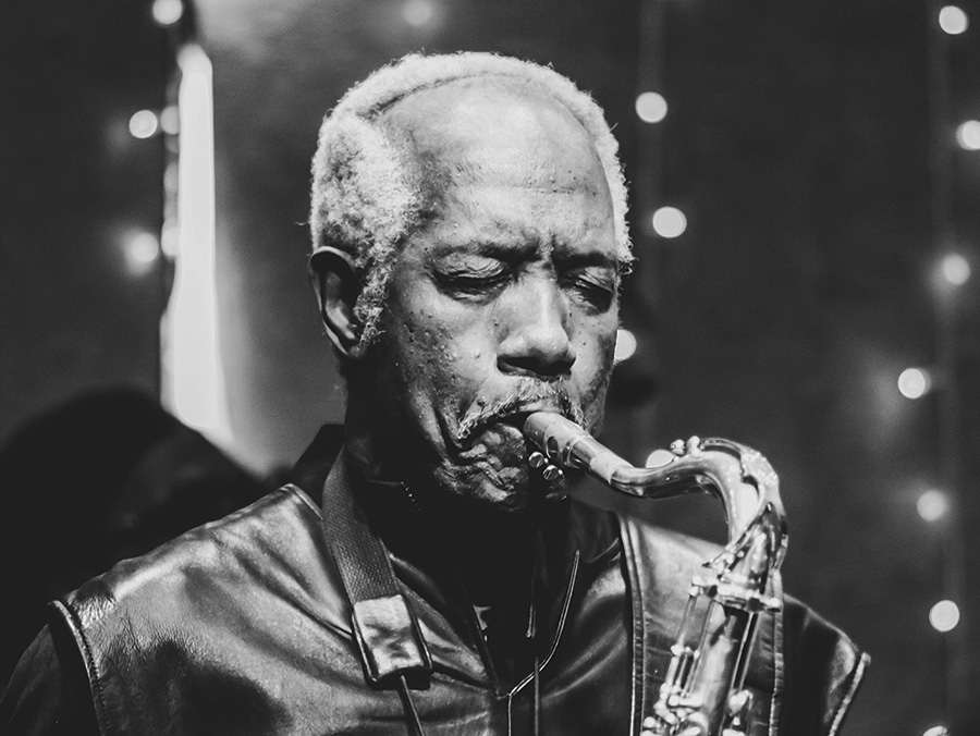 A black and white photo of Billy Harper playing the saxophone