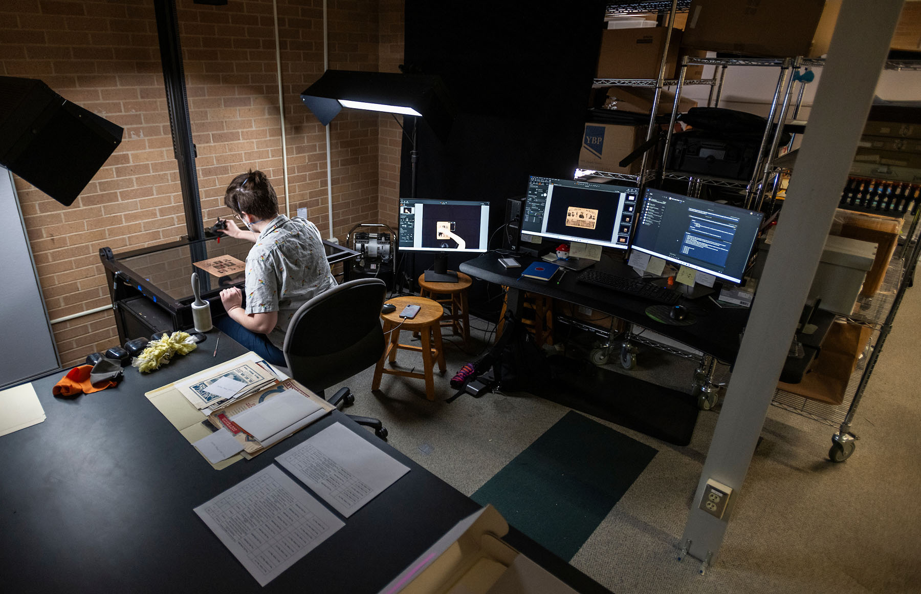 A student archivist works to restore a document inside UNT Special Collections' Digital Project Lab