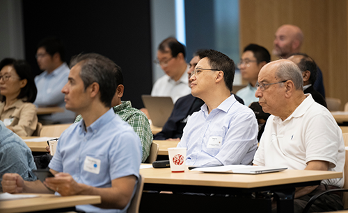 Group watching presentations at AI Collaboration Symposium