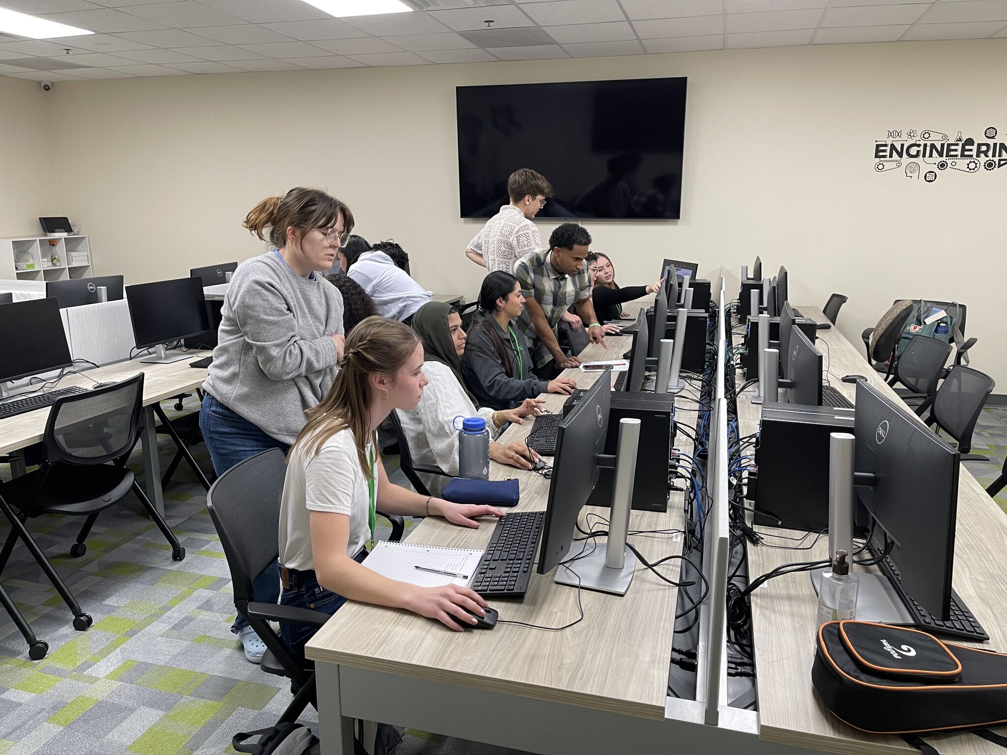 Students working on several computers during the Make-a-thon event