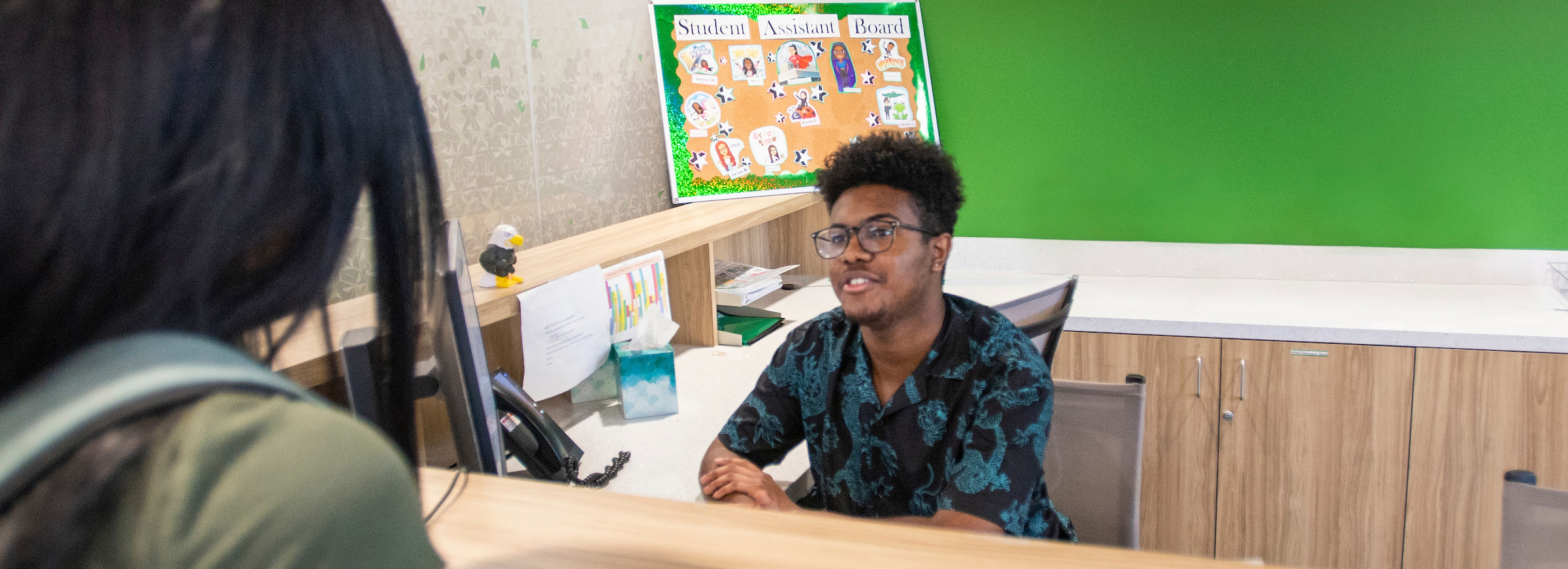 A student working the front desk at the Career Center