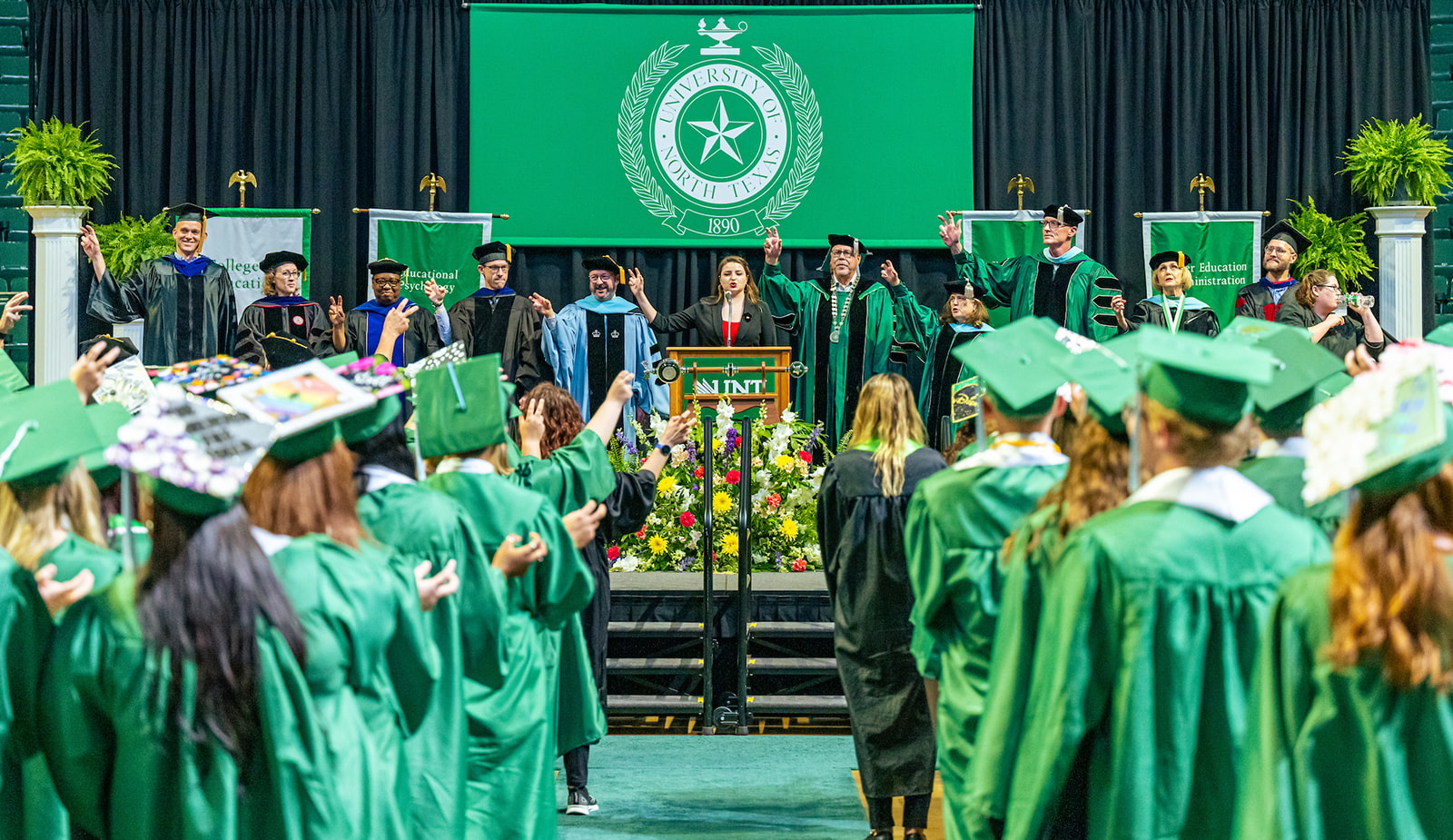 Graduates and speakers singing the Alma Mater