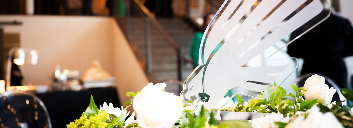 A white diving eagle acrylic award placed on a table