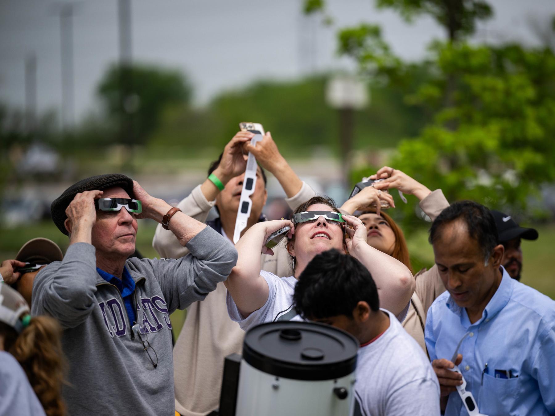 People watching the eclipse with eclipse glasses on