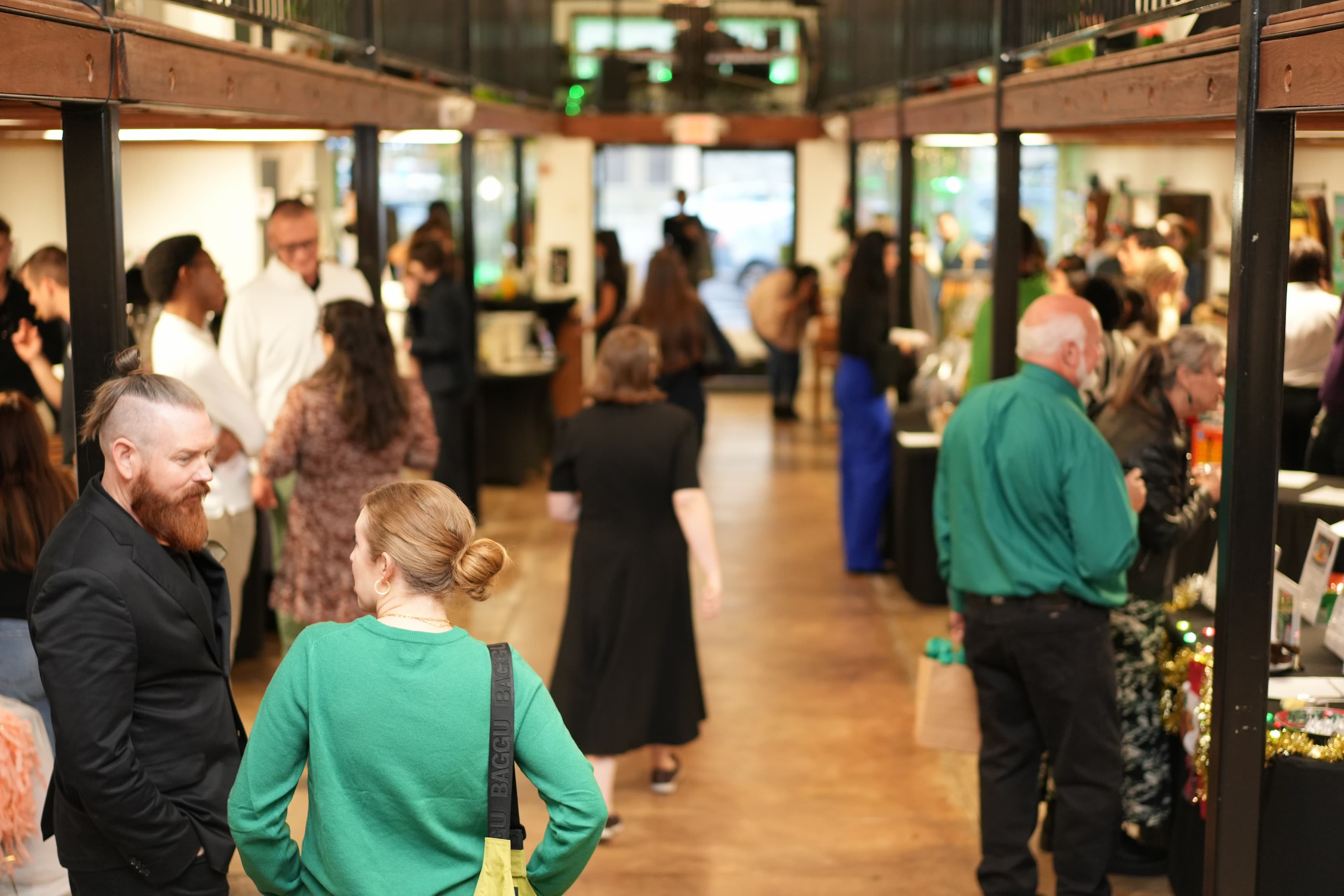 People attend an event hosted in an art gallery.