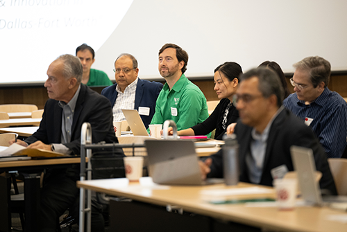 Group watching presentations at AI Collaboration Symposium