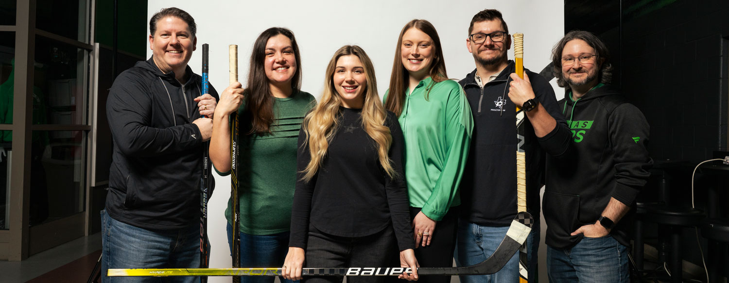 A photo of six people who work for the Dallas Stars all smiling.