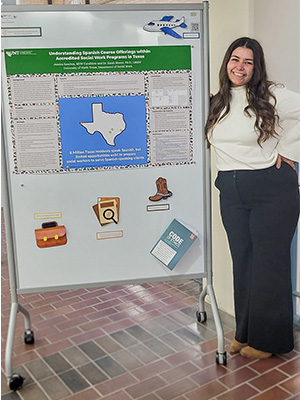 Jessica Sanchez stands in front of a research poster