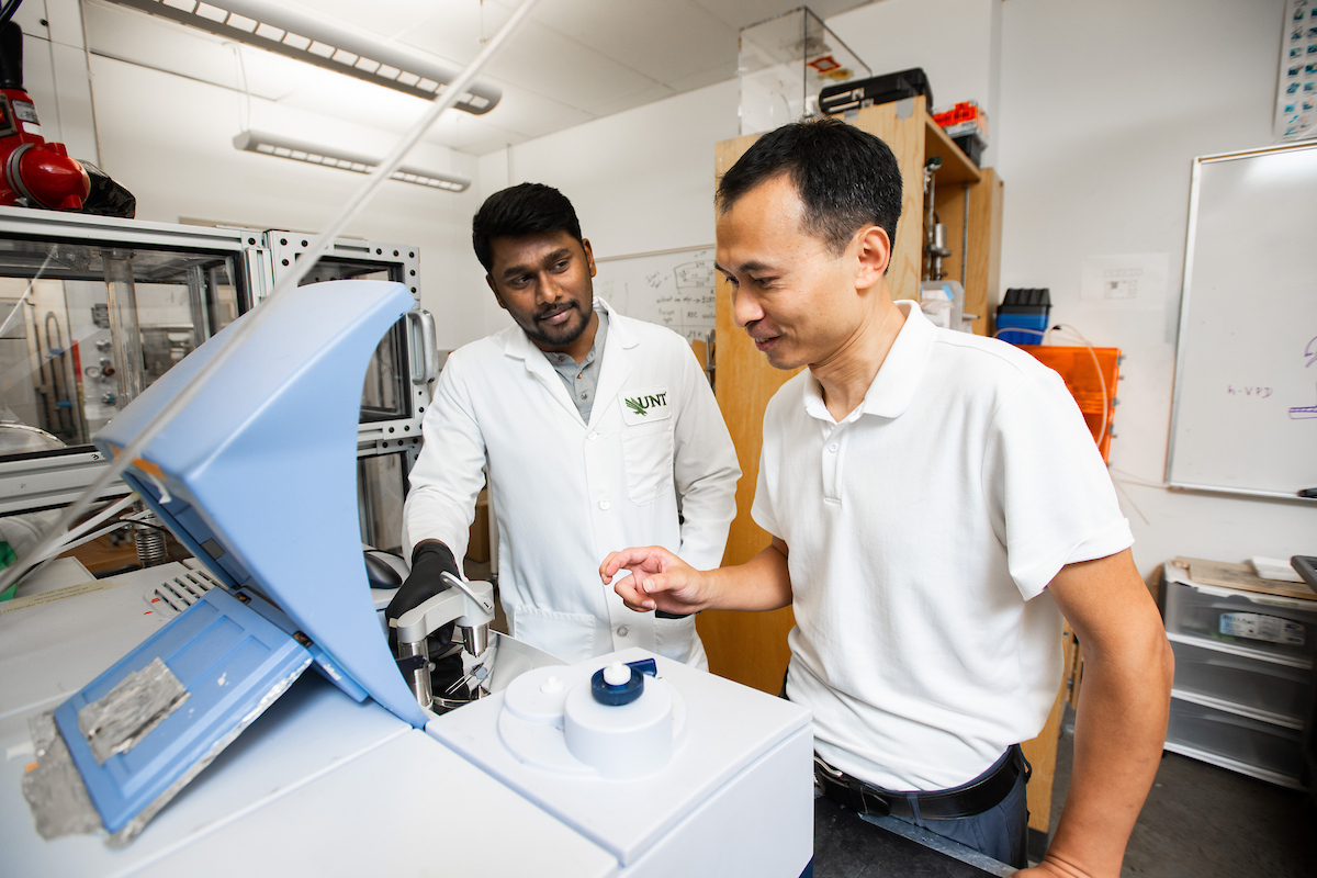 Chemistry graduate student Kevin Antony Jesu Durai and research associate Kui Tan with a spectrometer