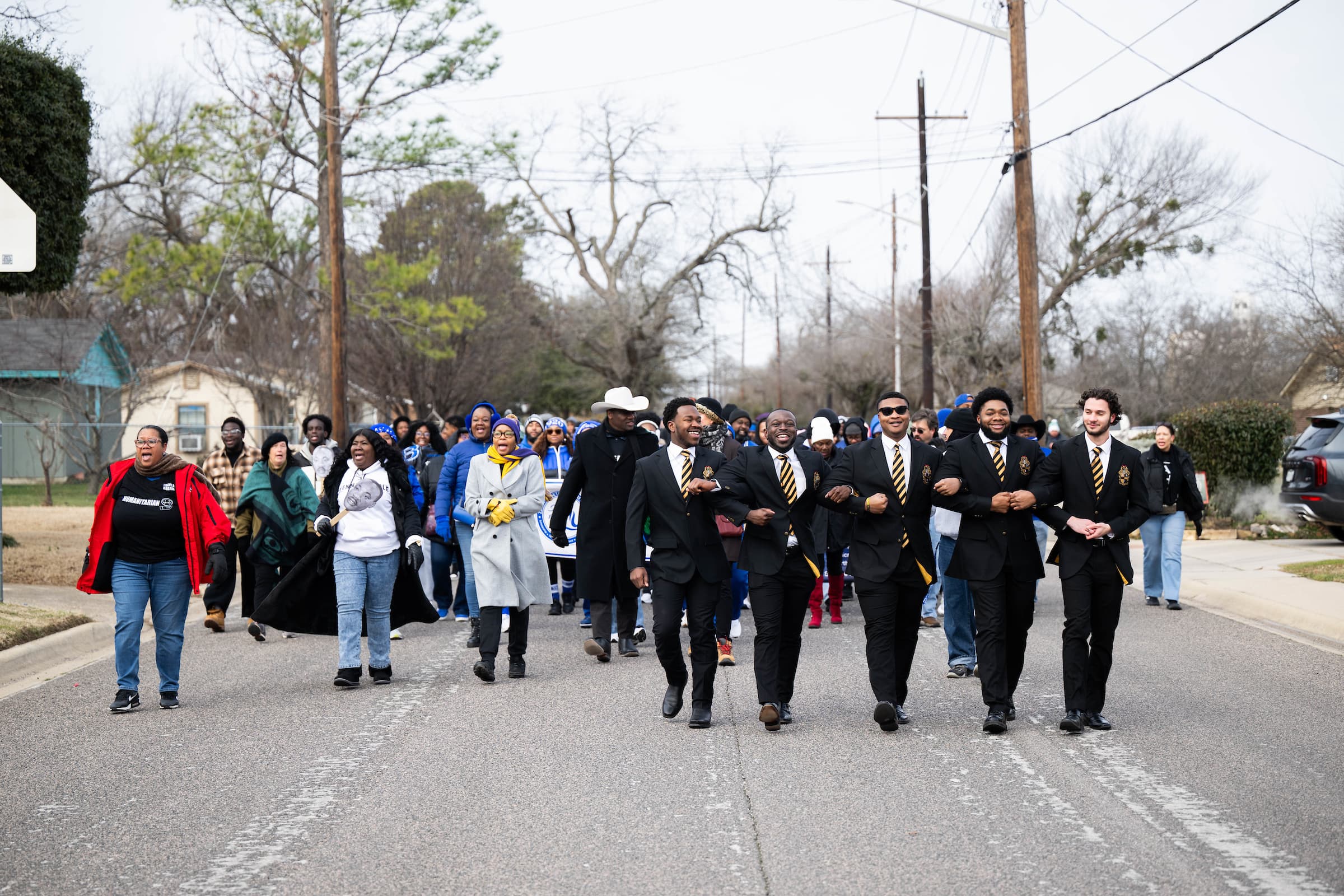 Denton residents and UNT students walk down a street as part of the March of Remembrance on MLK Jr. Day