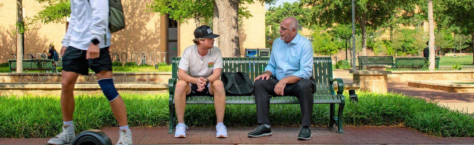 UNT president Neal Smatresk chats with a student on campus