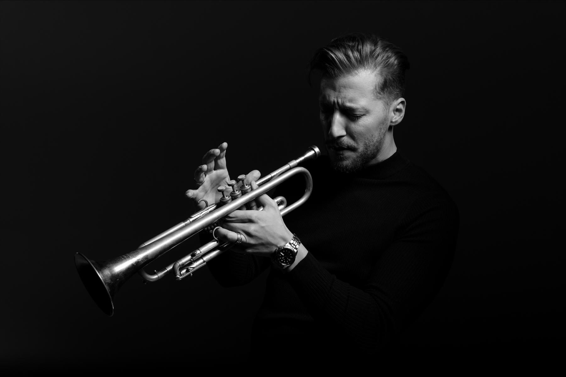 Black and white photo of Pilip Dizack playing the trumpet.