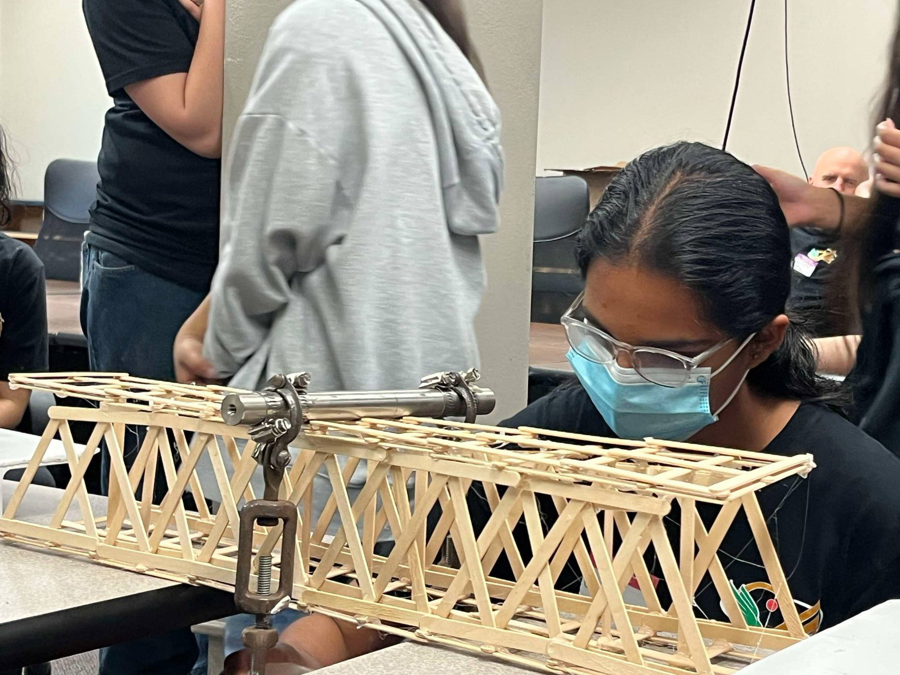 Students tested bridges made of popsicles sticks