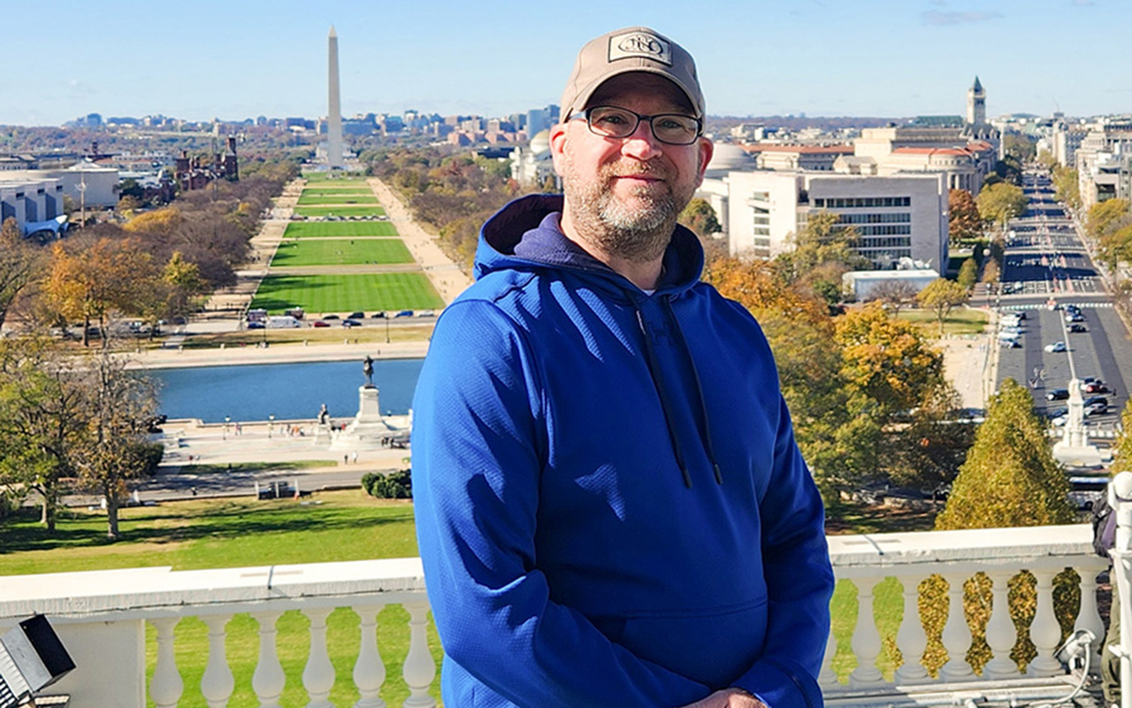 Asst. Chief Jeremy Polk stands on top of the White House overlooking the National Mall and the Washington Monument.