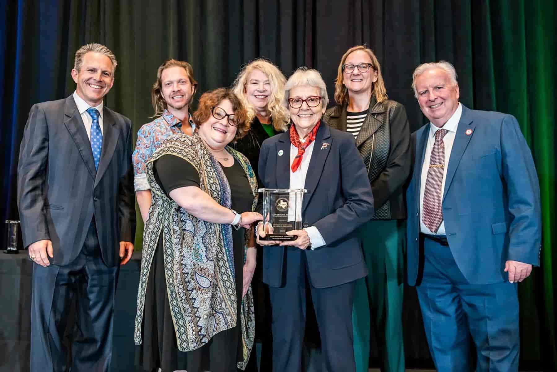 UNT Libraries staff pose for a photo while accepting an award