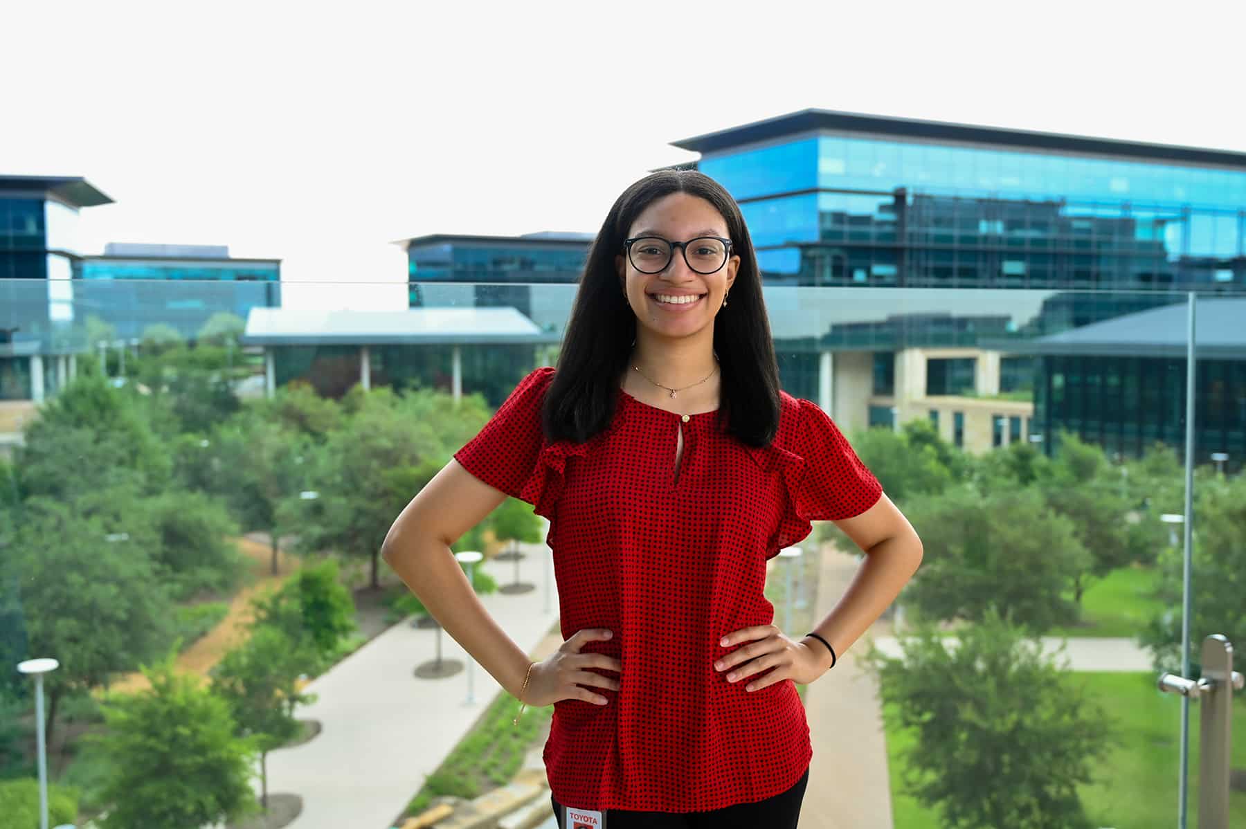 Rylee Hunter poses in front of office buildings