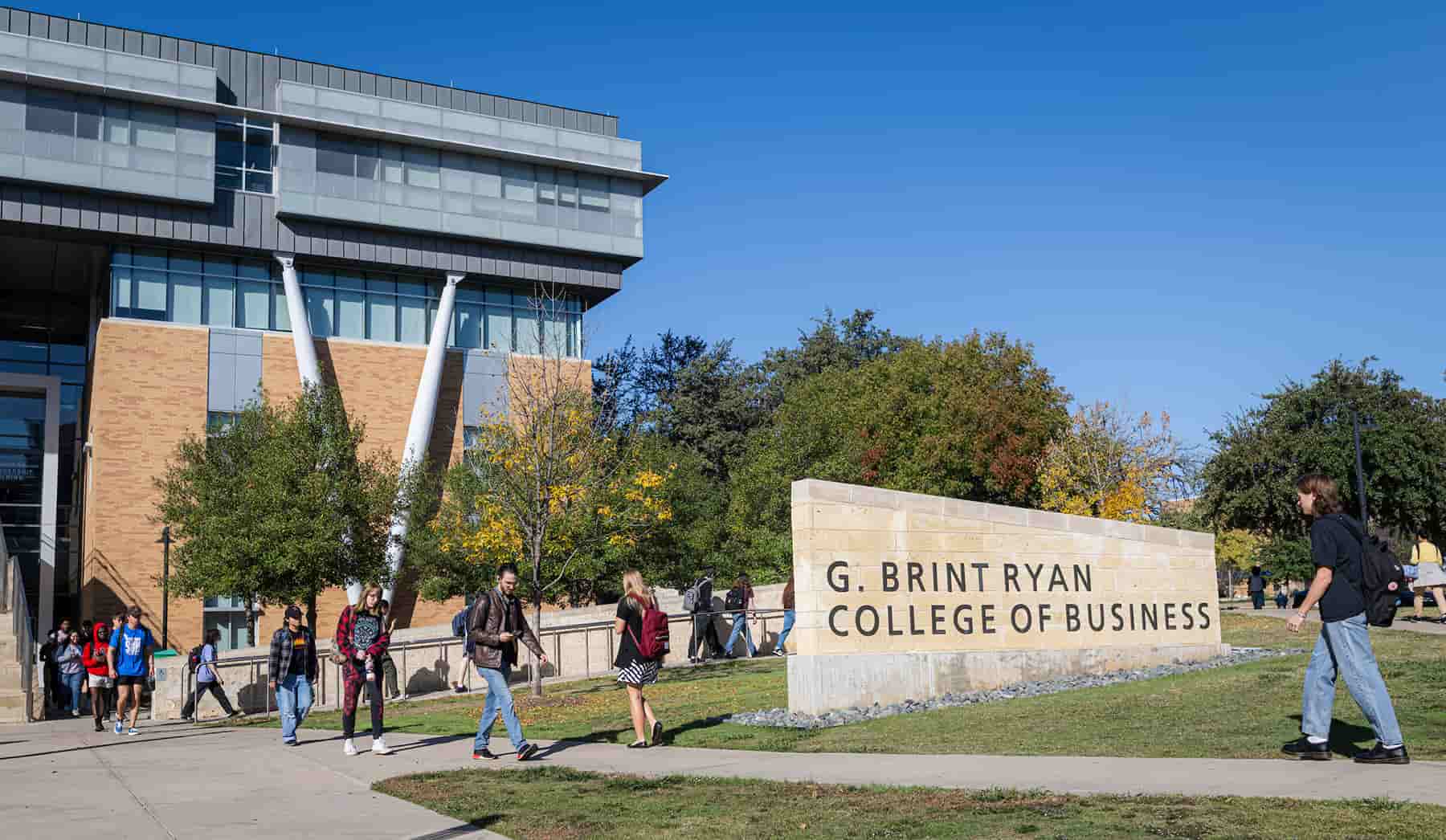 Students walk outside UNT's G. Brint Ryan College of Business building