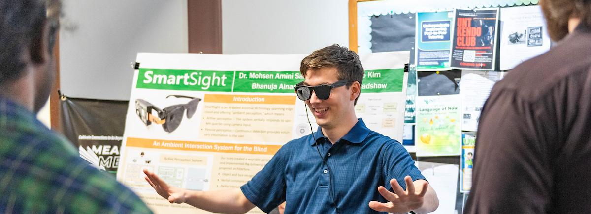 A student tests out a project wearing special sunglasses with a sensor on them