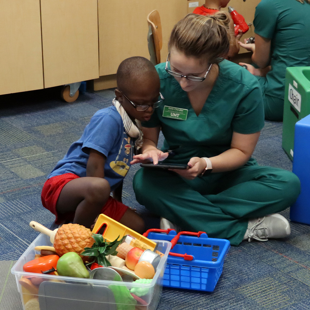 Student, Katie Chandler, helping a child at the Speech and Hearing Center