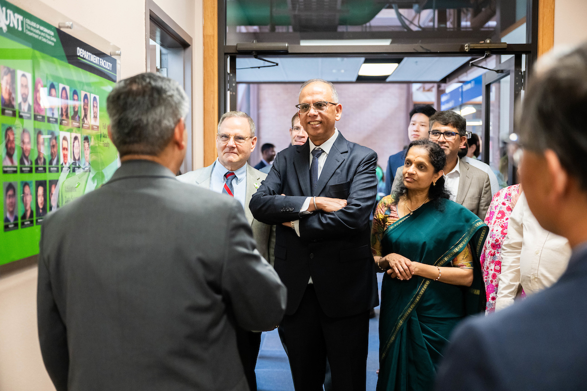 The Sinha's speak to someone who's back is to the camera