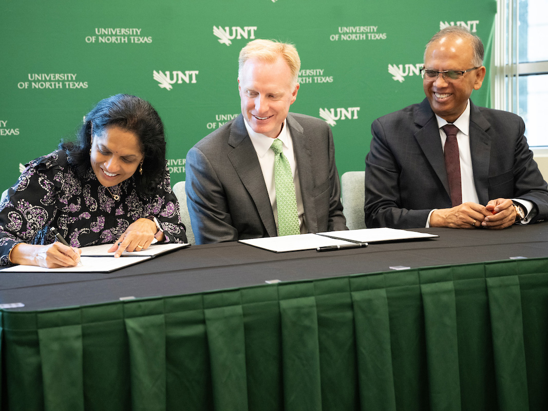 Anuradha Sinha, UNT President Harrison Keller and Vikas Sinha celebrate the signing of the Sinha’s $3 million gift