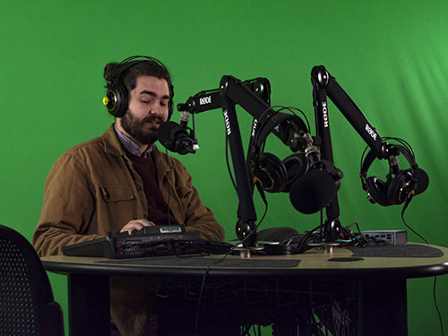 Deane Marshall, media technical manager for the Mayborn School of Journalism, tests podcast studio equipment