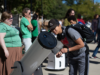 Person looking through a telescope