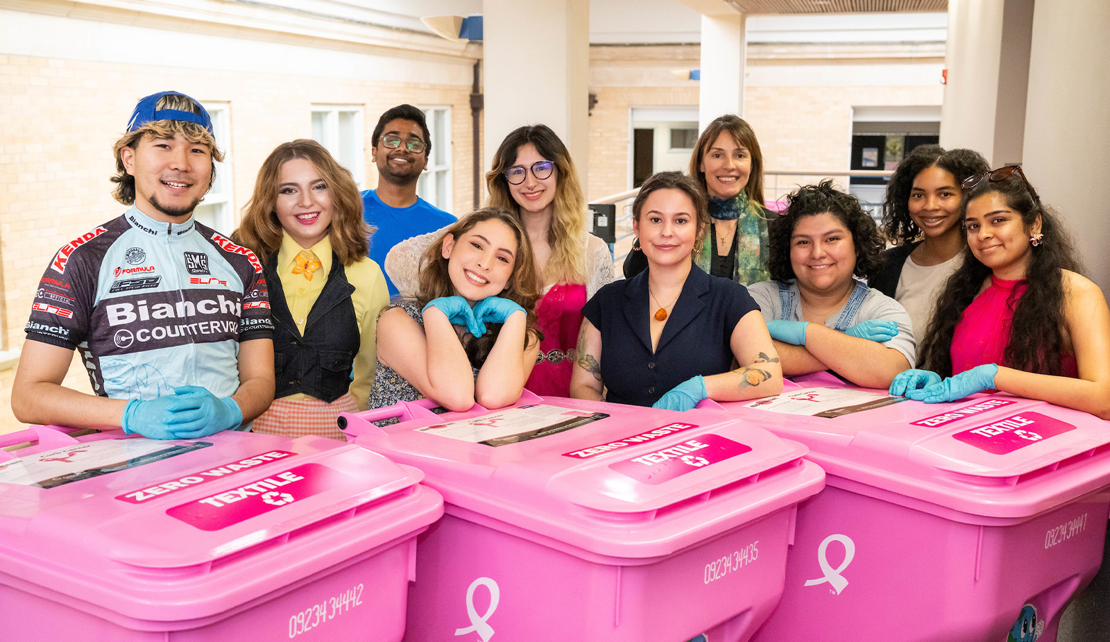 Group of students posing with recycling bins