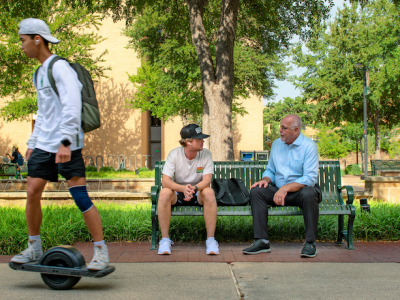 UNT president Neal Smatresk chats with a student on campus