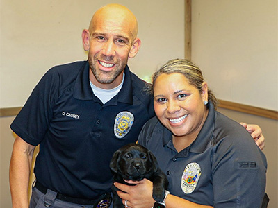 Corporal David Causey (left) with Chief Ramona Washington (right) picking out UNT Police’s new community support dog