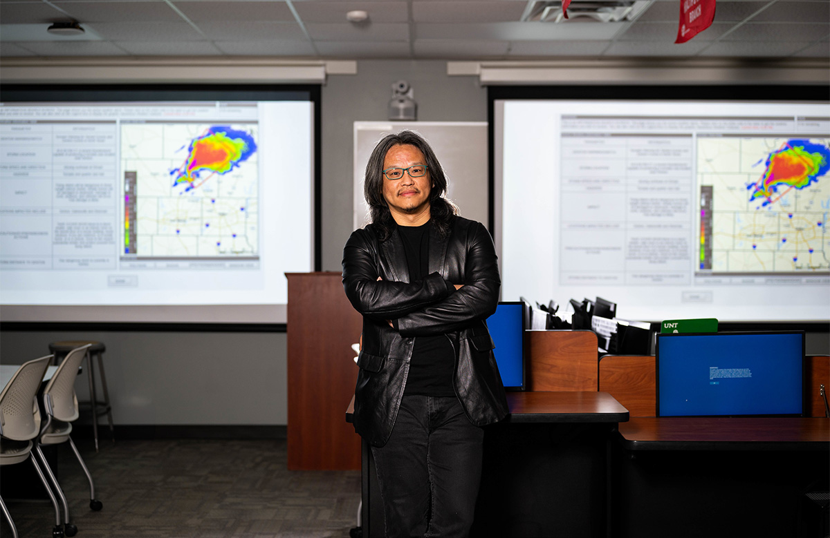 Tristan Wu posed in front of two classroom whiteboards