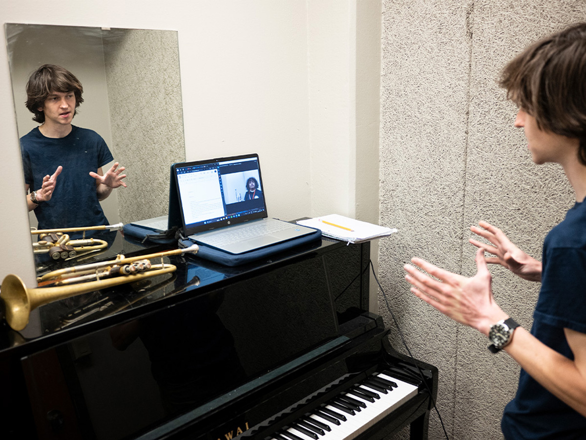 Nathan Fisher in a virtual music lesson with a Dallas ISD student 