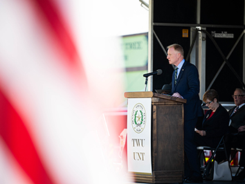 Speaker at the podium on Veterans Day at the Denton Courthouse Square.