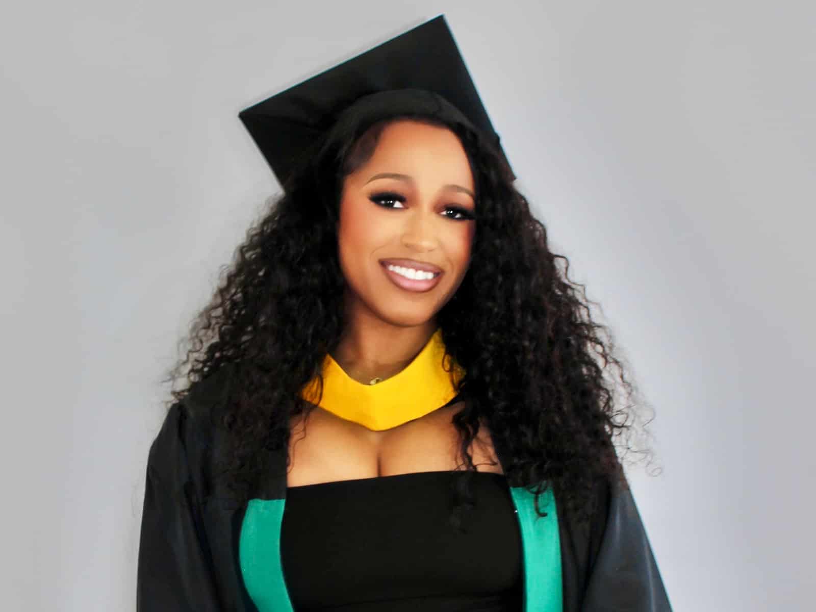 Student posing in graduation regalia
