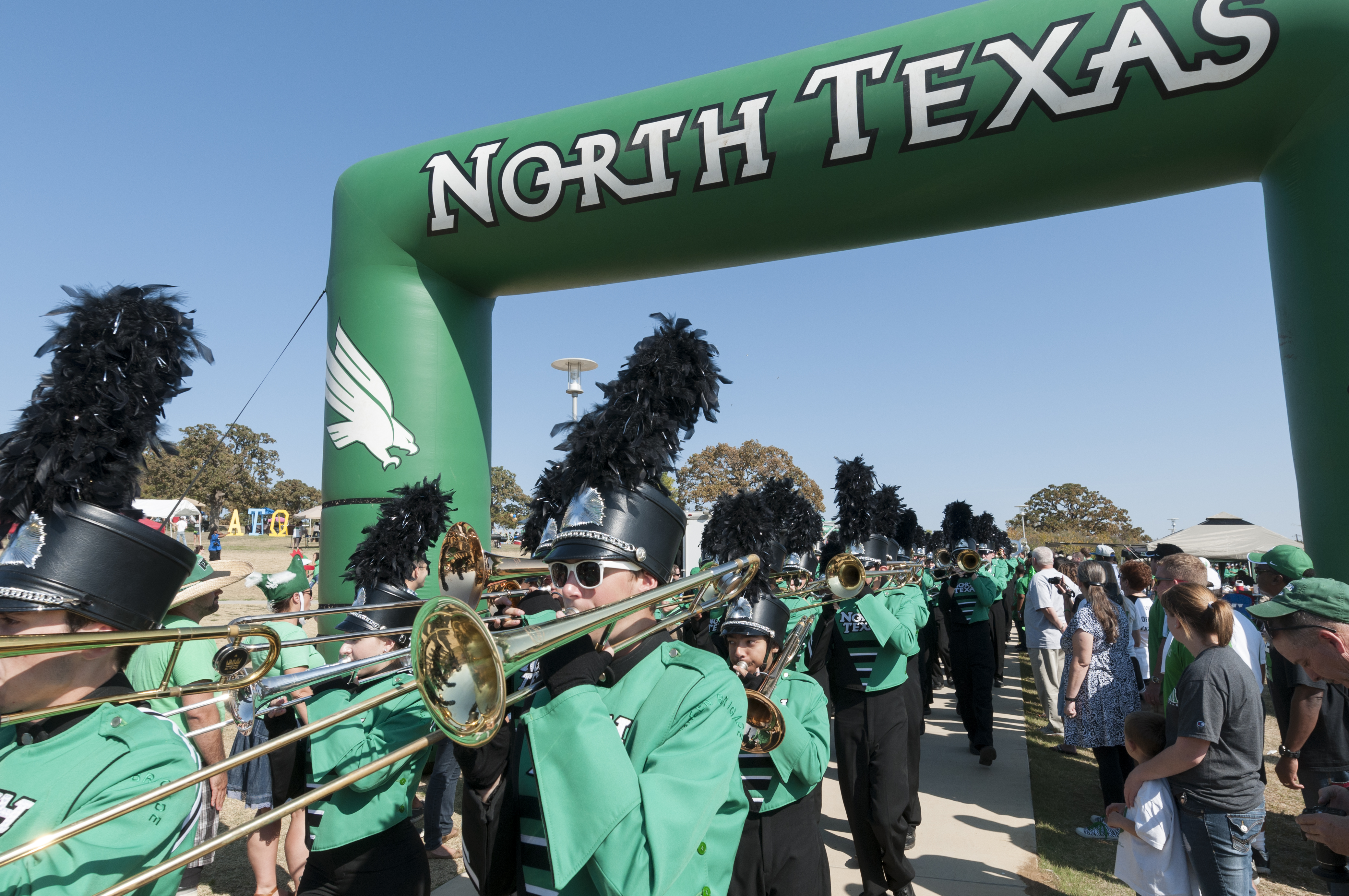 The University of North Texas Green Brigade Marching Band entering the field.