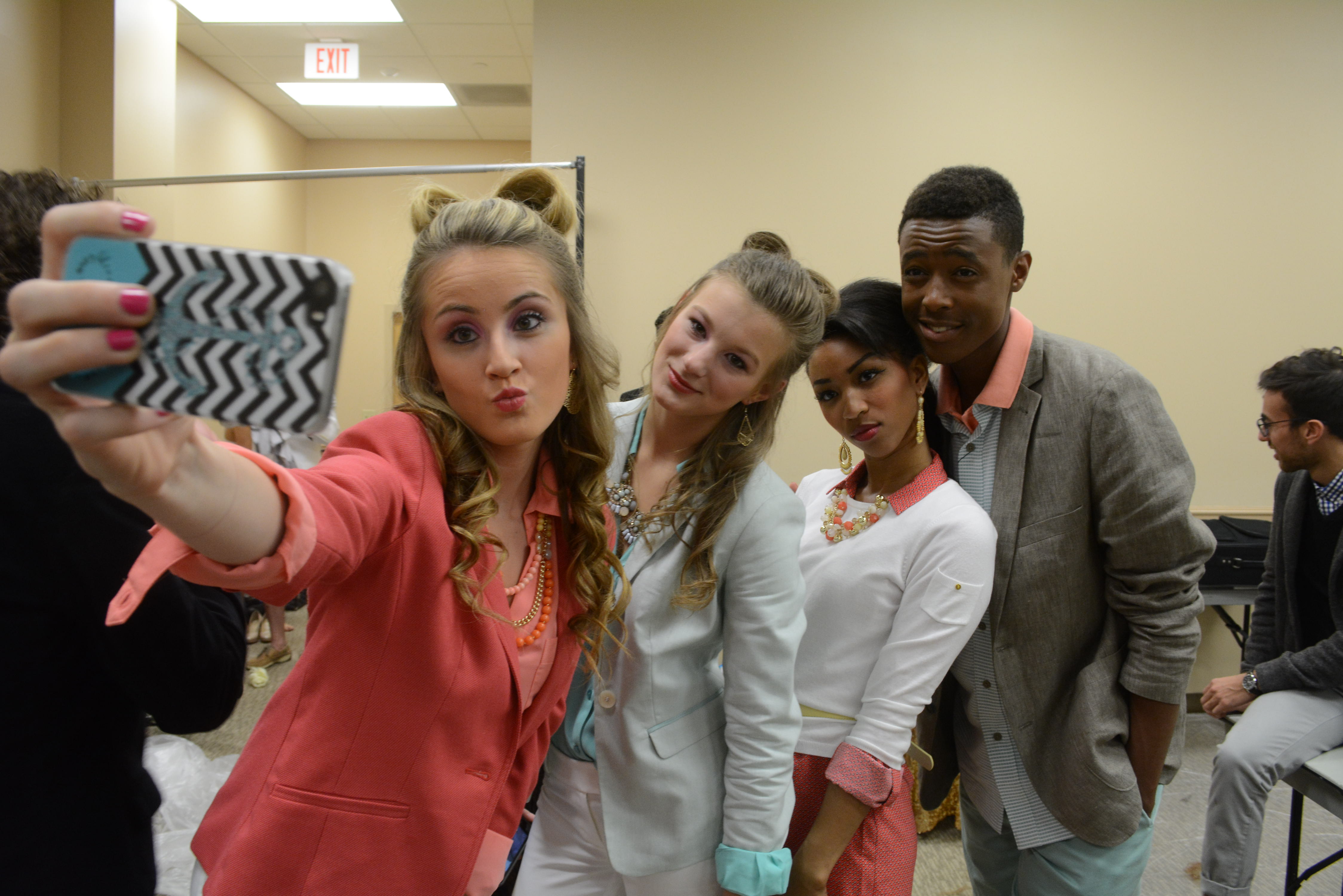 A behind the scenes look at the spring 2015 Merchandising Inc. fashion show features UNT student models taking a selfie during the event. This year's theme 