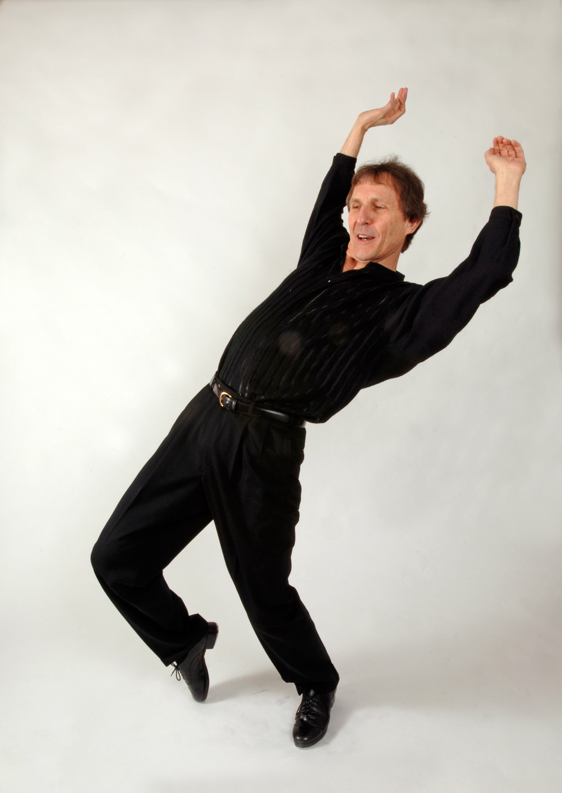 Bill Evans, in a studio photograph dance pose, dressed black