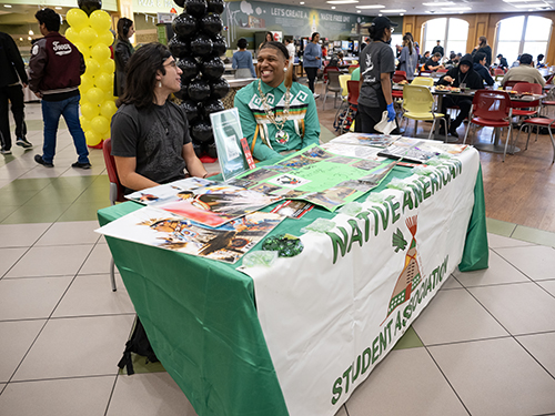 Reymond Salazar (left) and Deante' Moore (right) provide information during Native American lunch event at Bruceteria