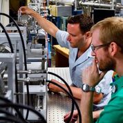 UNT Physics researchers Todd Byers (foreground) and Jack Manual conduct a proton induced x-ray emission (PIXE) analysis on dust.